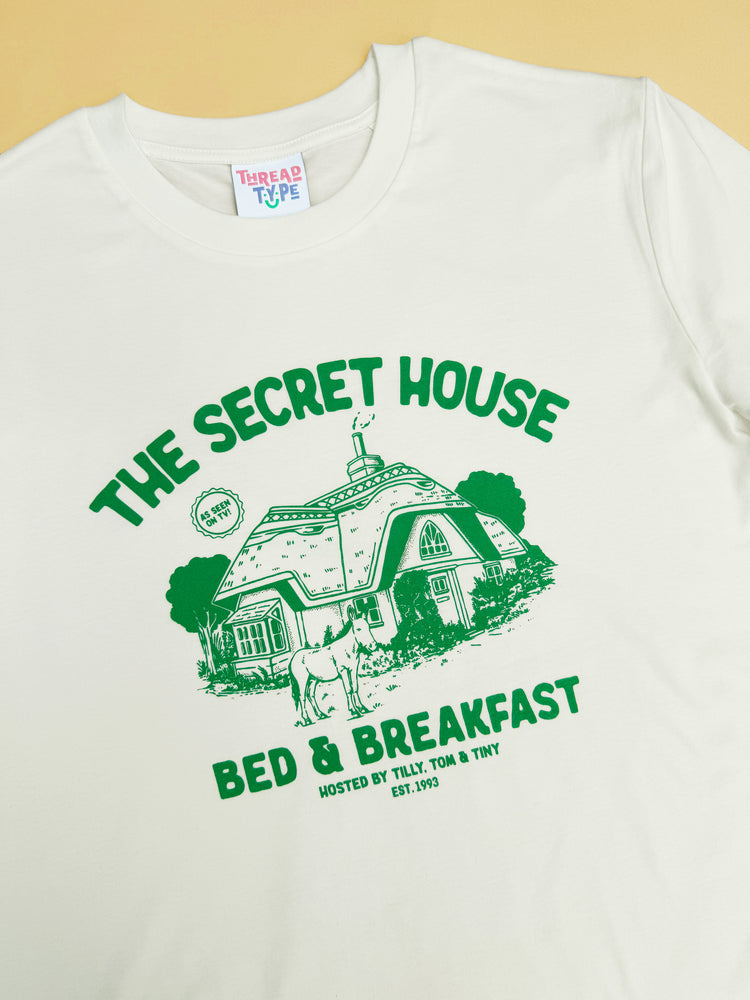 Another close up of 90s TV show Tots TV inspired T-shirt design featuring a hideaway cottage and donkey!