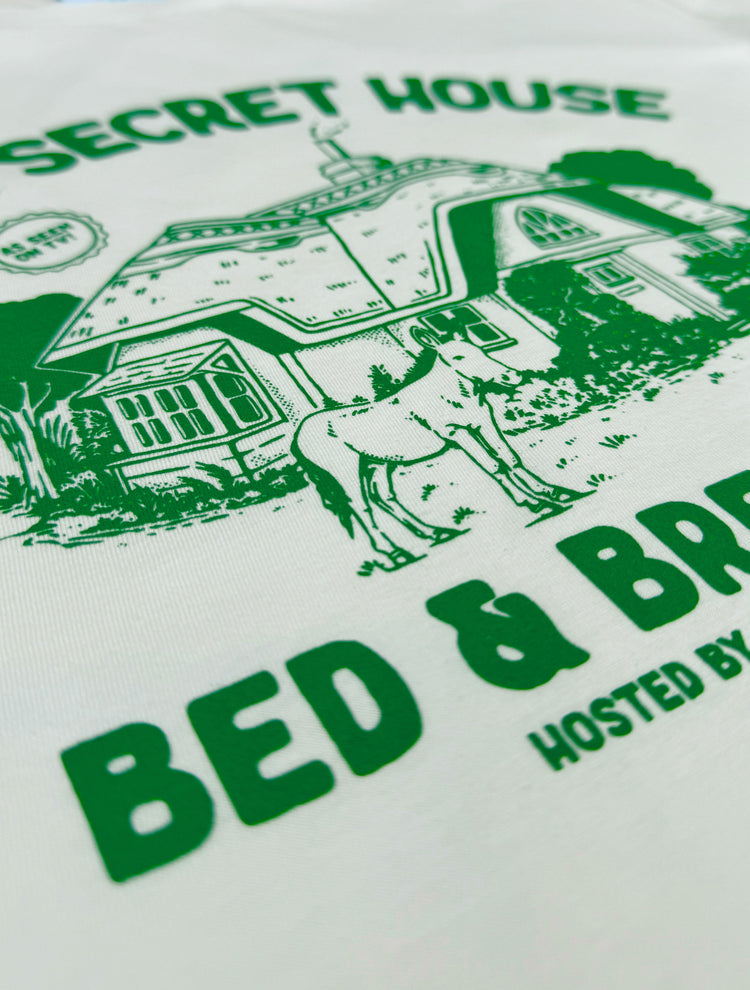 Close up of 90s TV show Tots TV inspired T-shirt design featuring a hideaway cottage and donkey!