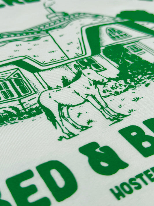 Close up of 90s TV show Tots TV inspired T-shirt design featuring a hideawy cottage and donkey!