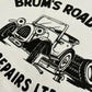 A close up shot of our 90s TV Show Brum inspired T-shirt design featuring a car with eyes in a car workshop