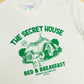 Another close up of 90s TV show Tots TV inspired T-shirt design featuring a hideaway cottage and donkey!
